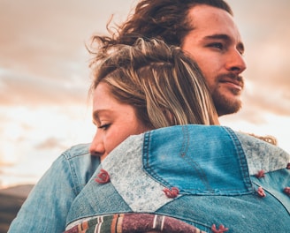 selective focus photography of couple hugging