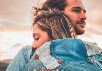 selective focus photography of couple hugging