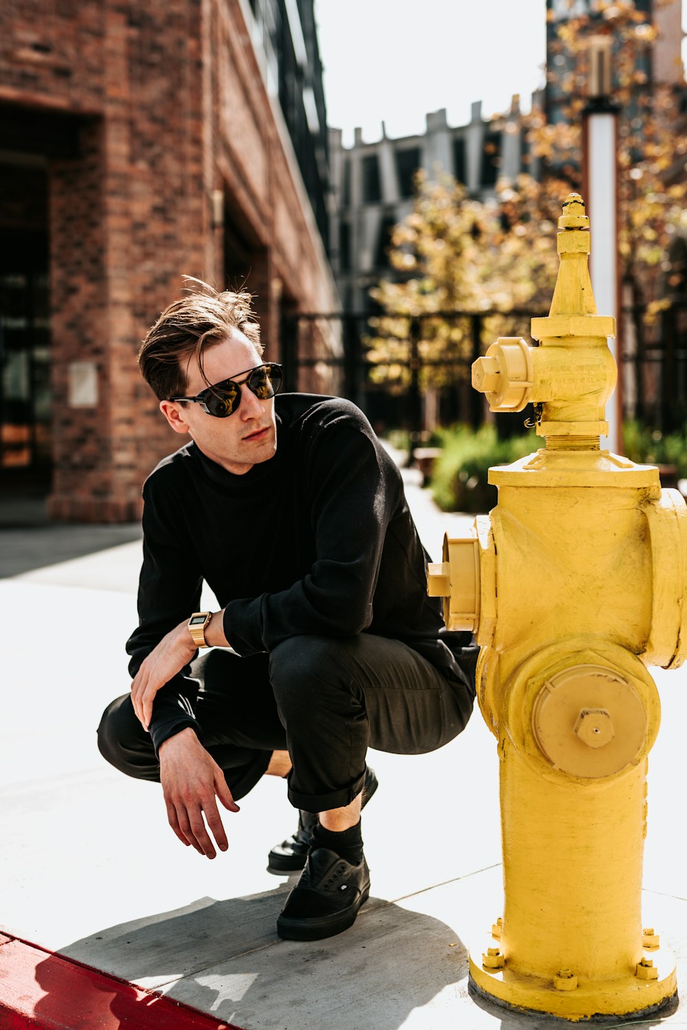person posing beside fire hydrant