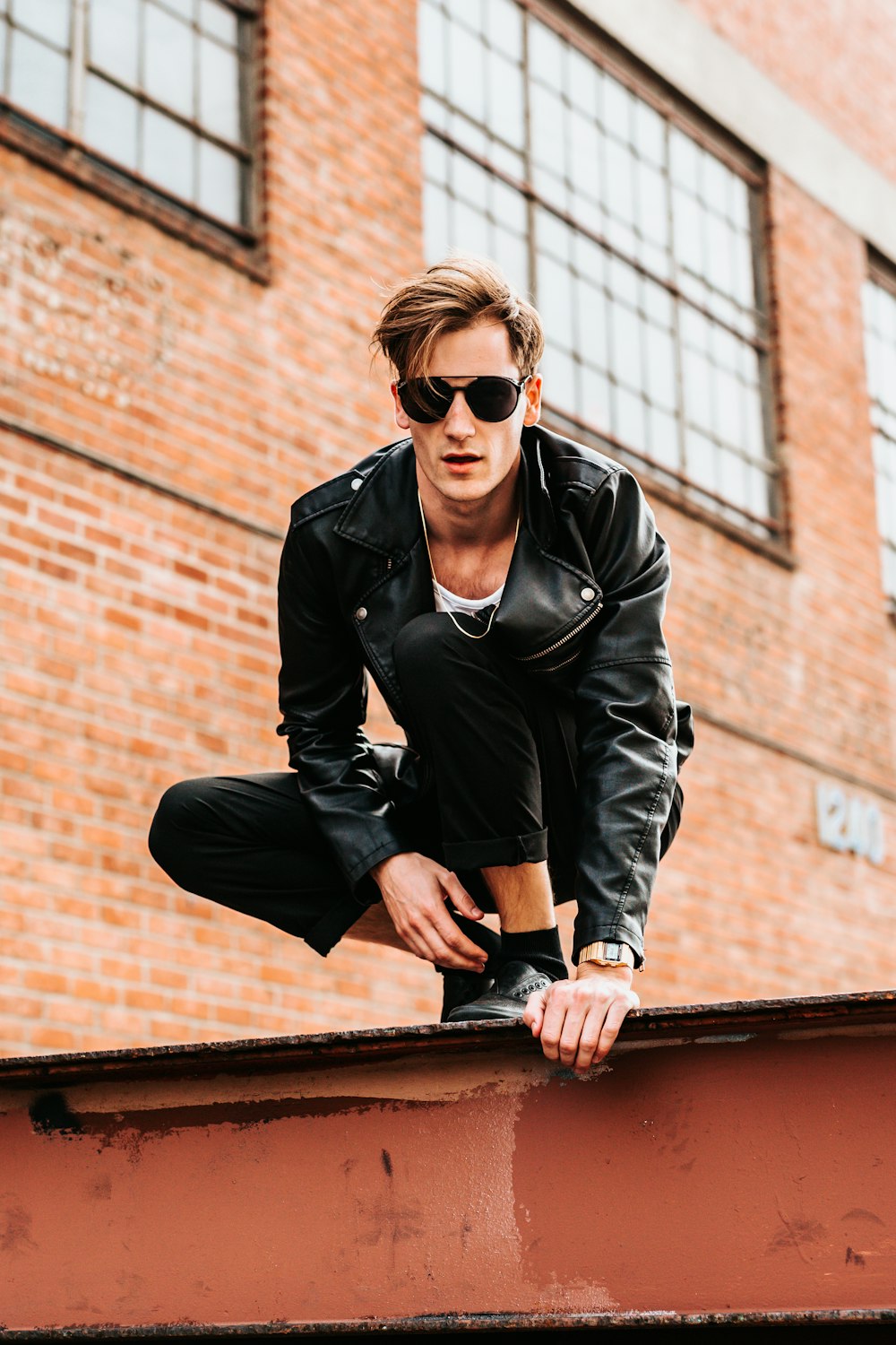 man sitting on red roof