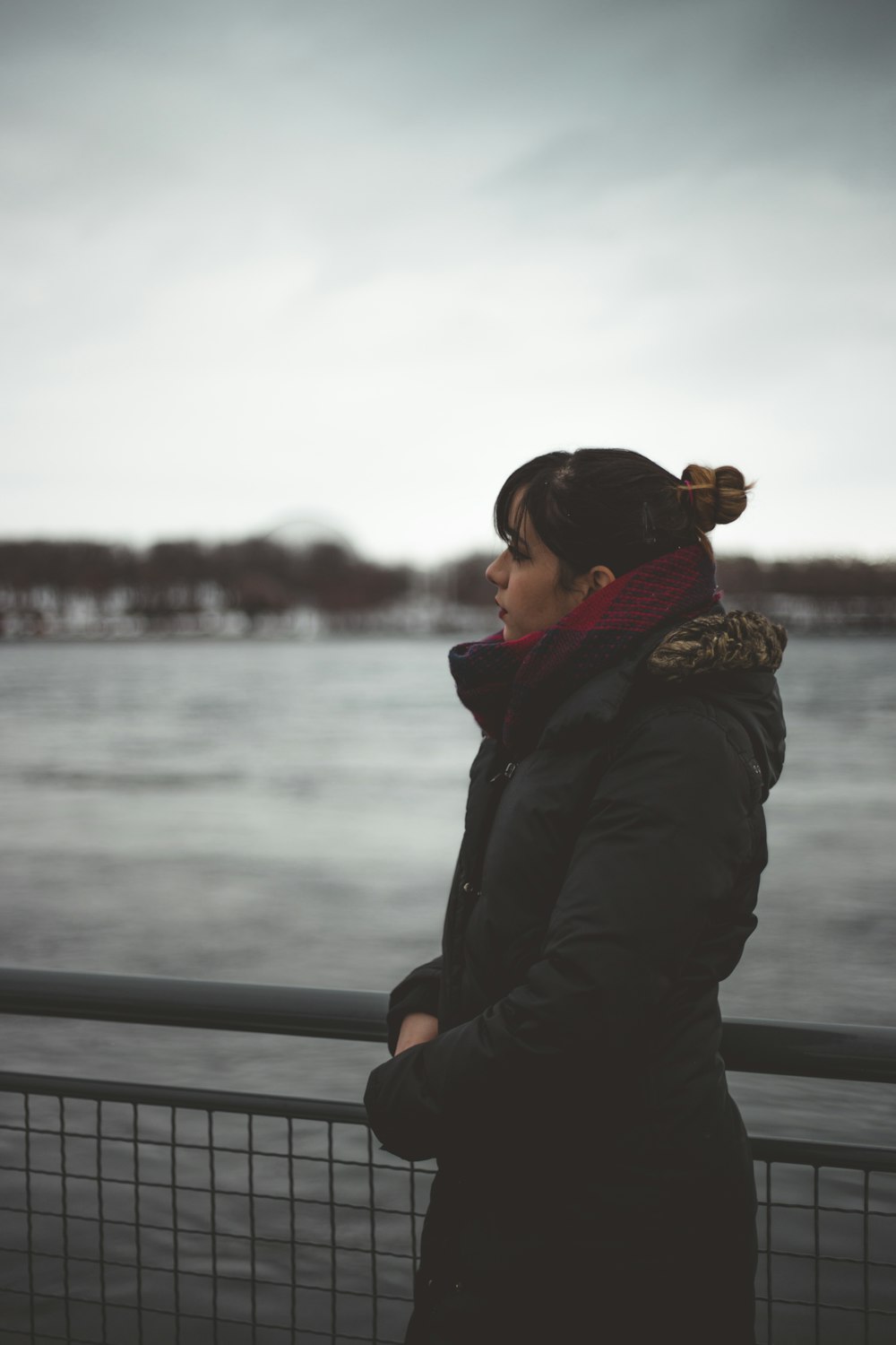 woman standing next to fence