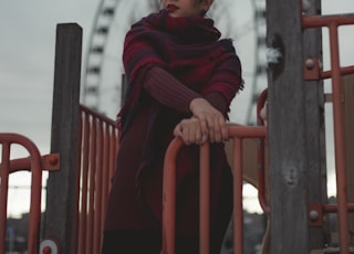 woman holding on to a red metal railing
