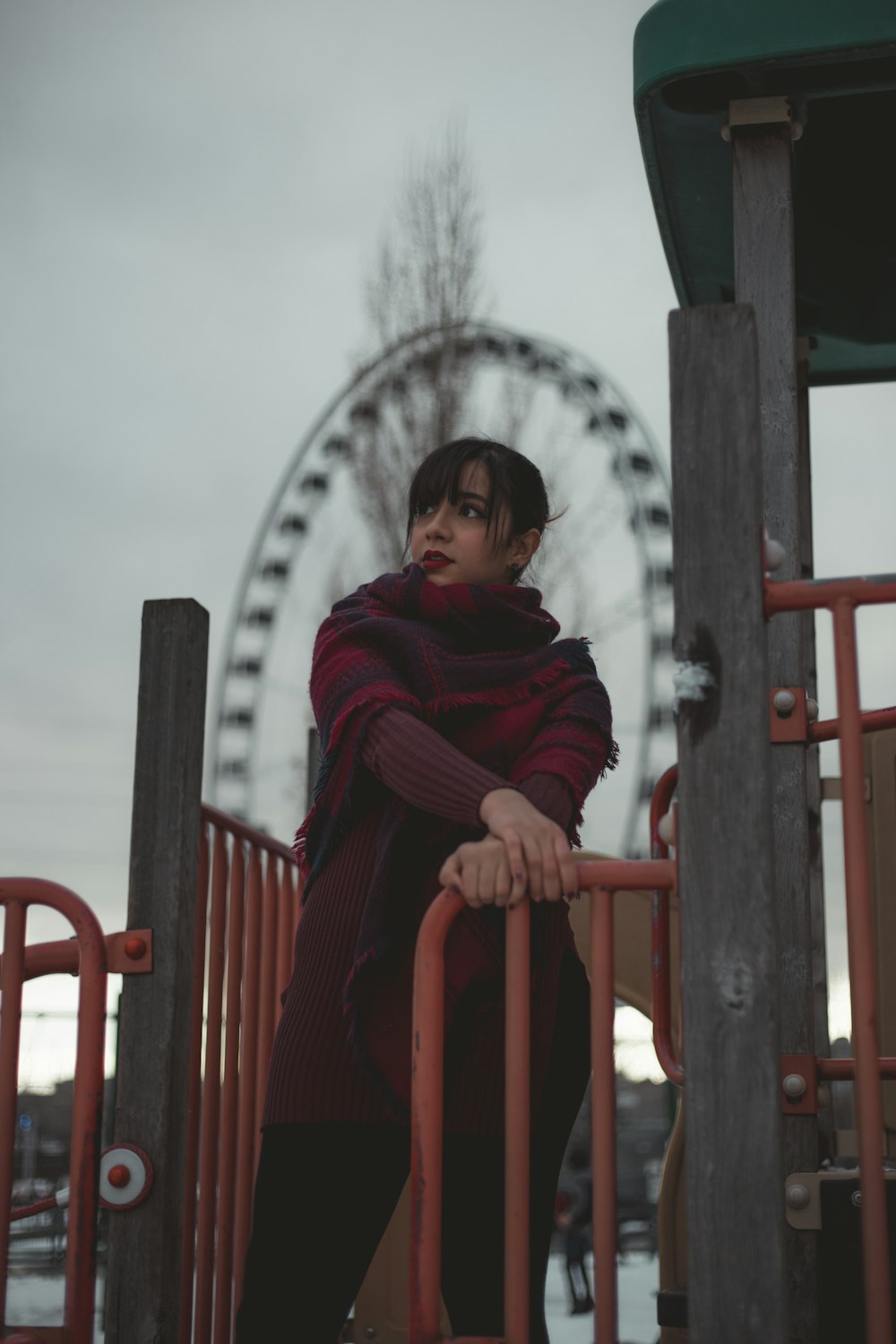 woman holding on to a red metal railing