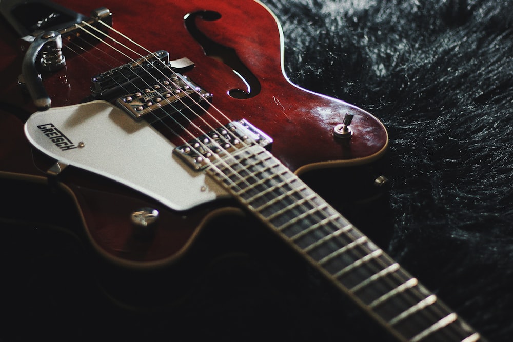 white and red electric guitar