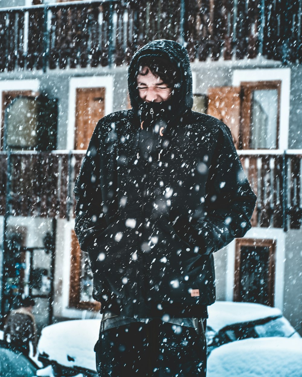 man in black hooded jacket during snow rain