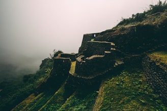 Fog rolling over cracked stone ruins in a forgotten onsen.