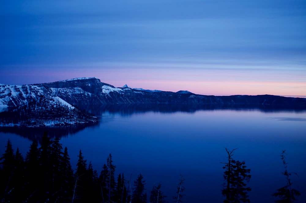 mountain near body of water over the horizon