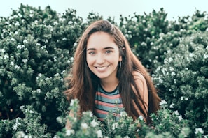 woman standing in bushes