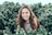woman standing in bushes