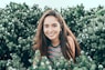 woman standing in bushes