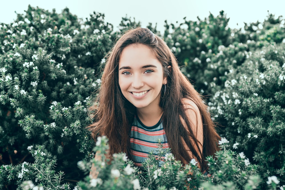 woman standing in bushes