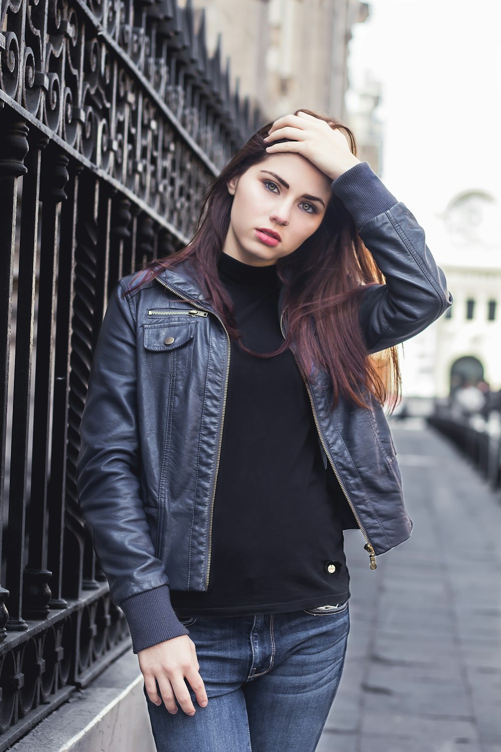 woman standing near black steel fence