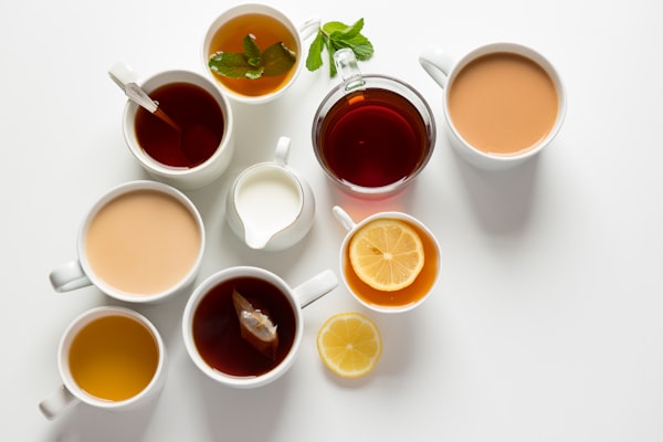 multiple cups with different types of tea and milk