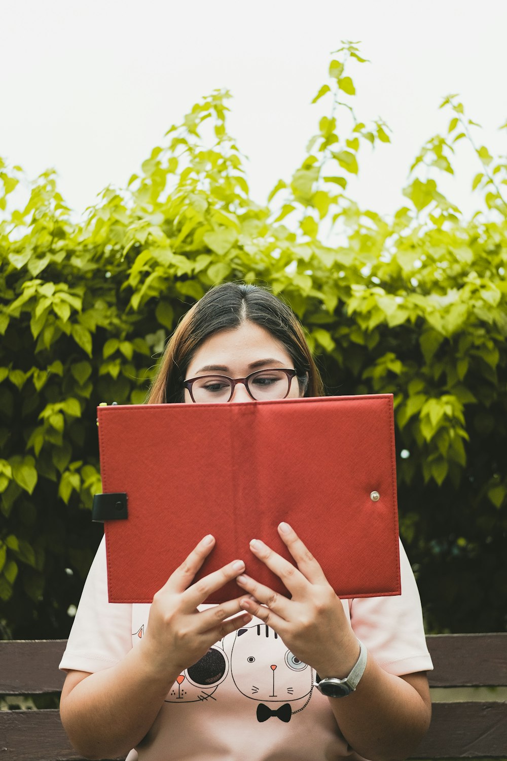 woman sitting on beach while reading