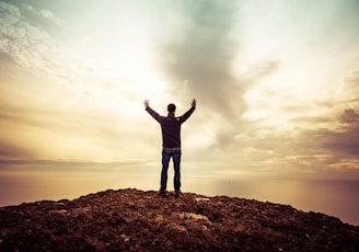 man standing under orange sky