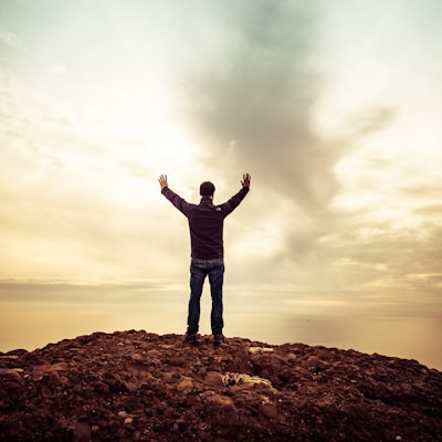 man standing under orange sky