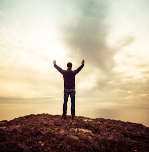 man standing under orange sky