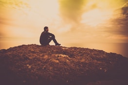 A serene outdoor scene with a person looking thoughtfully at the horizon, contemplating love.