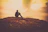 A person quietly contemplating the horizon during early morning light.