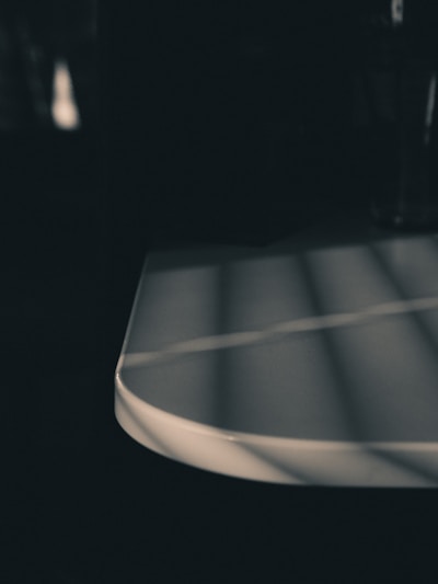 A minimalist empty table with soft natural light highlighting its simplicity.