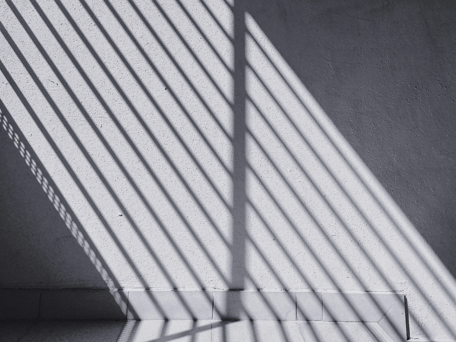 Shadow across a wall in sharp geometry — the structure behind Residence Governance is invisible when it works