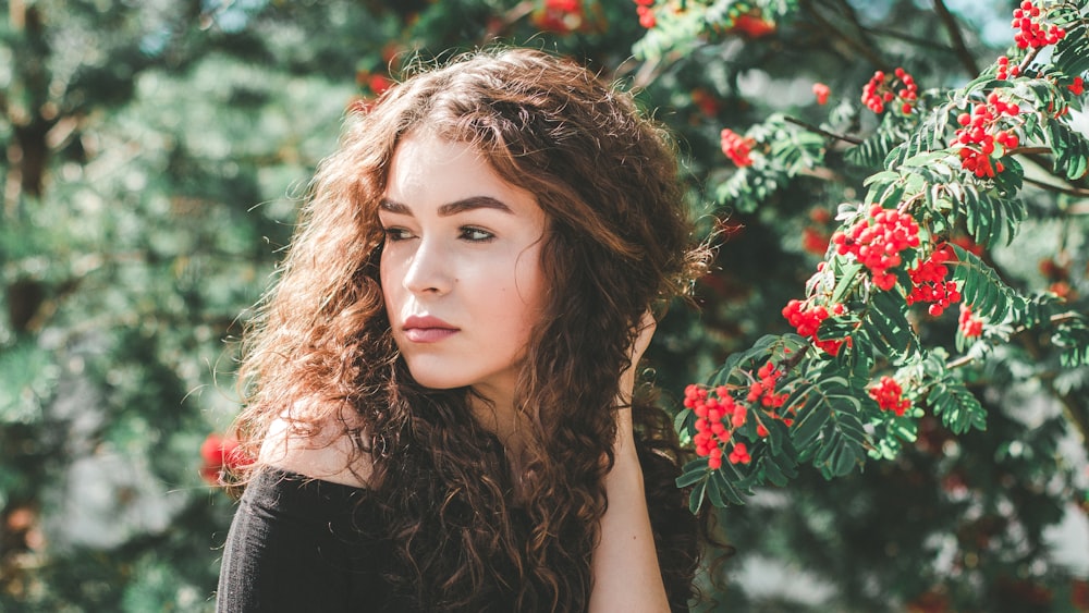 woman posing near flowers