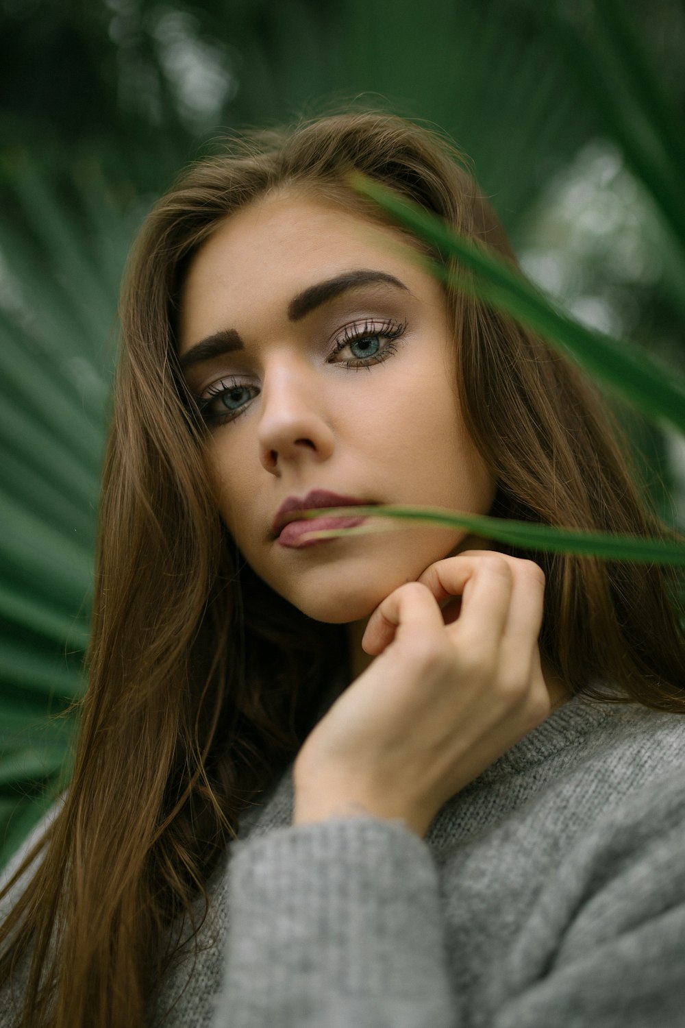 woman left hand touching on neck