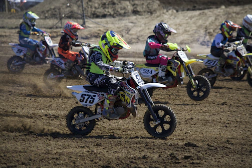 Colorful action photo of children competing in the International KidsTrophy race.