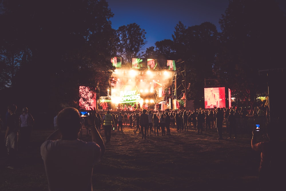 man taking a picture of concert