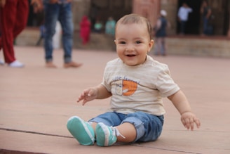 A happy toddler wearing a soft, colorful outfit playing outdoors on a sunny day