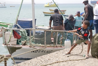 Children learning to tie fishing knots during a hands-on workshop led by experienced anglers.
