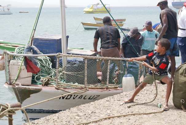 Children learning to tie fishing knots during a hands-on workshop led by experienced anglers.