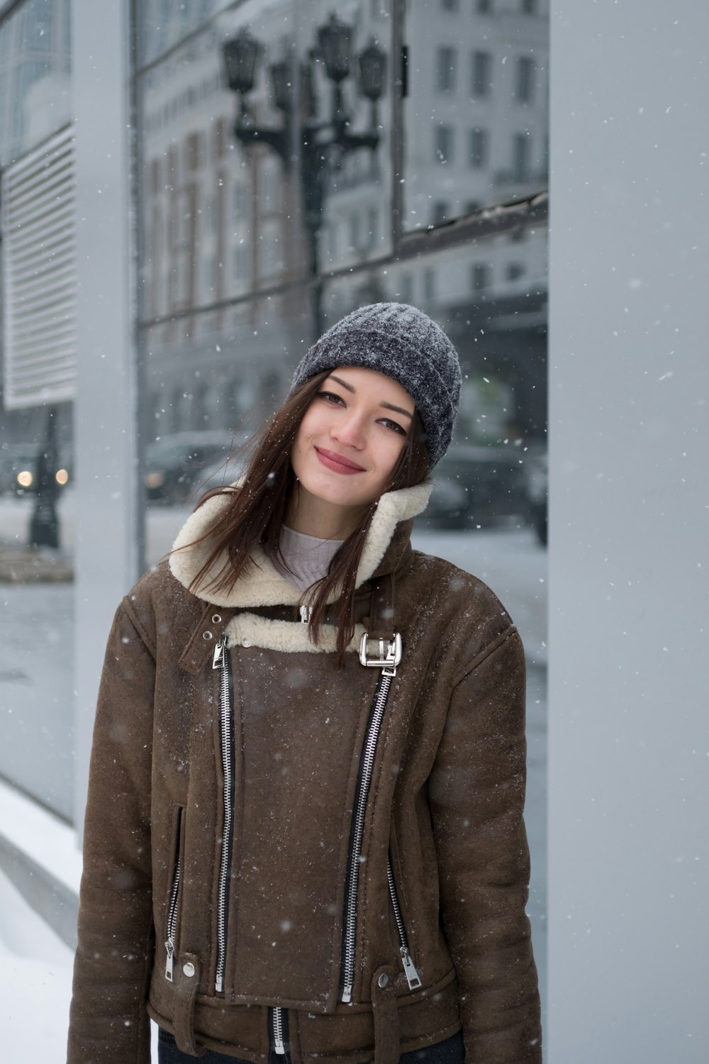 woman leaning on wall taking selfie