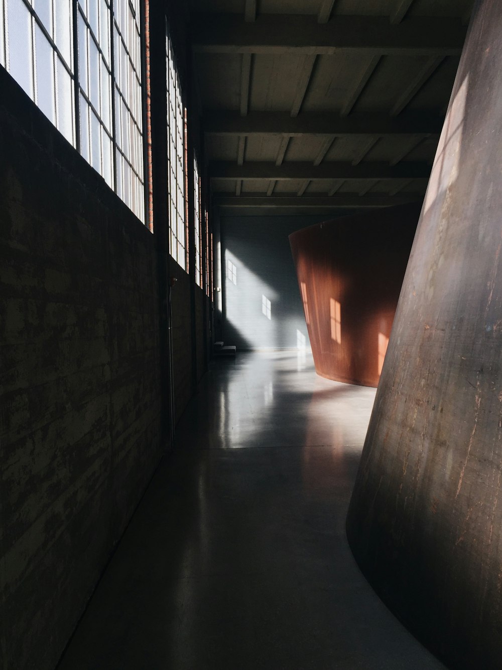 a dark room with a large metal object in the middle of it