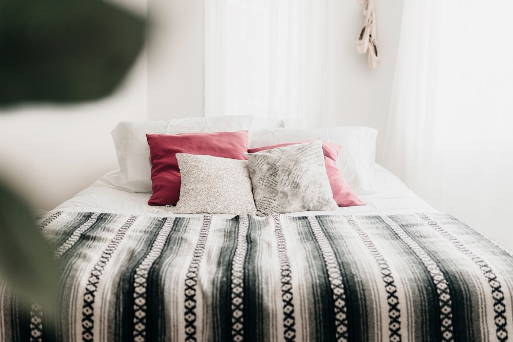 bed with throw pillows and blanket