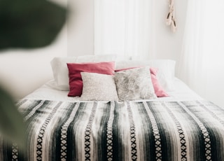 bed with throw pillows and blanket