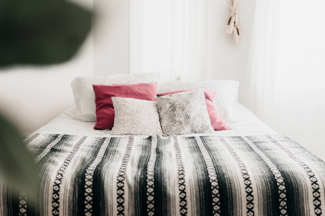 bed with throw pillows and blanket,