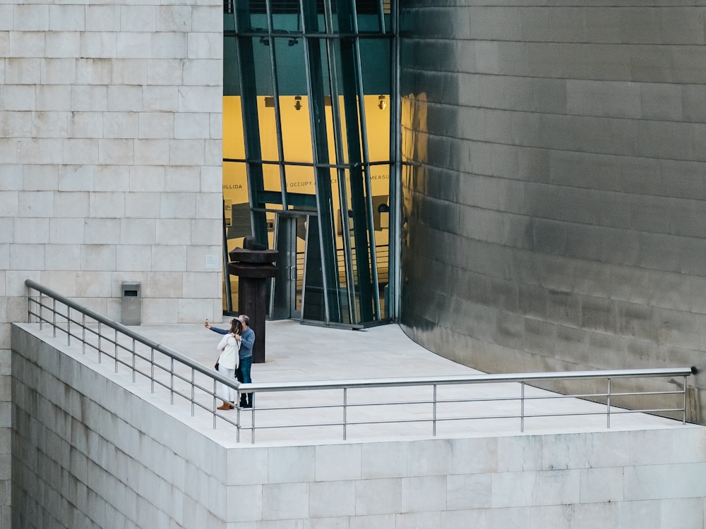 couple taking picture together on top of building