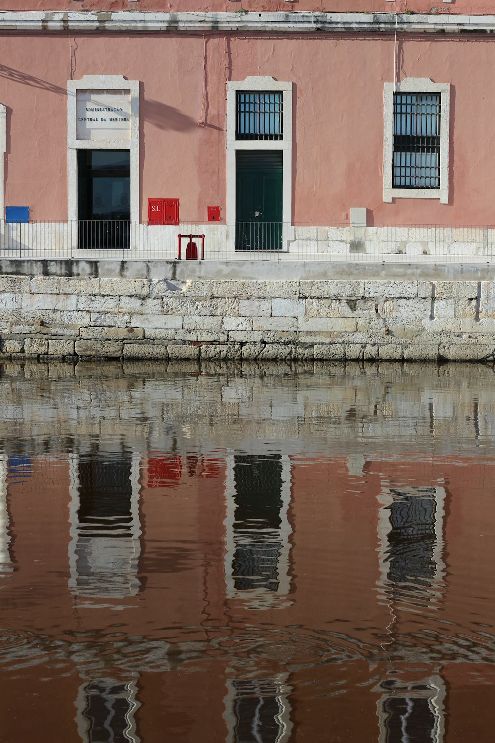 brown and white concrete building near body of water during daytime