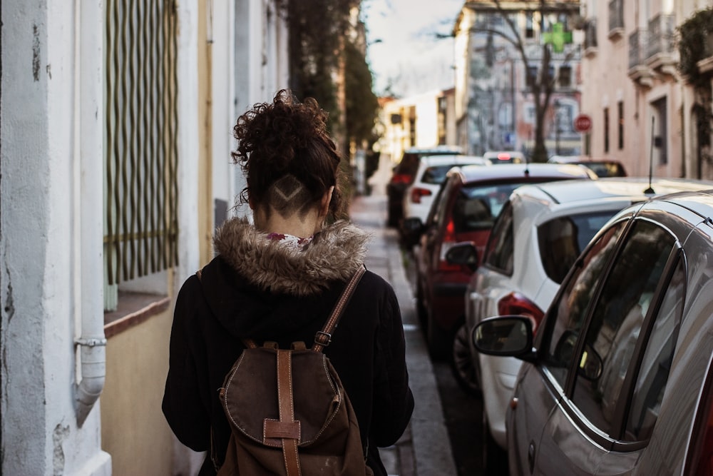 woman walking on sidewalk