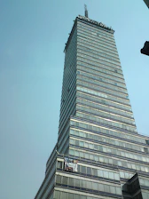 Vibrant outdoor banner displayed on a storefront with clean metallic highlights.