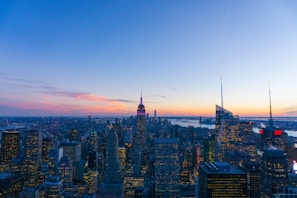 A panoramic cityscape showcasing towering skyscrapers owned by kush holdings at dusk.