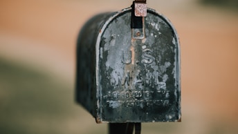 closeup photography of black U.S. mailbox