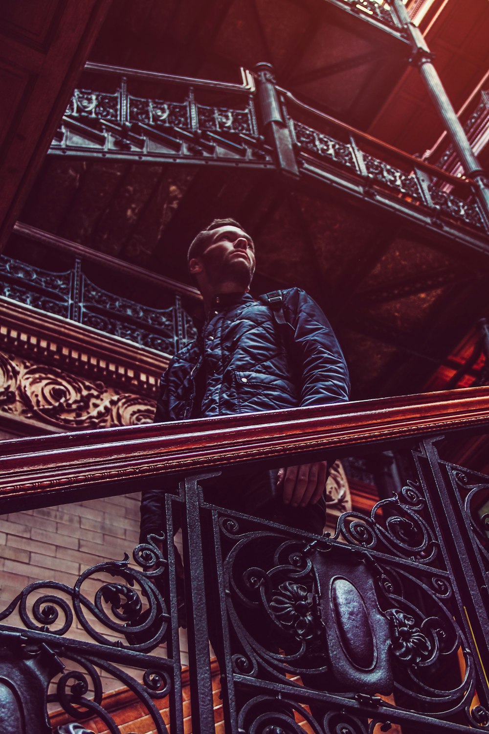 man standing on brown stairs