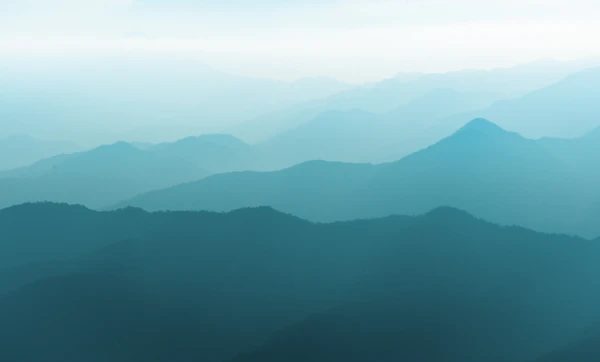 Warm lodge interior with a stone fireplace