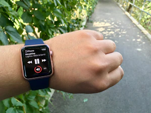 A vibrant scene showing a person using a smartwatch while enjoying a morning jog in the park.