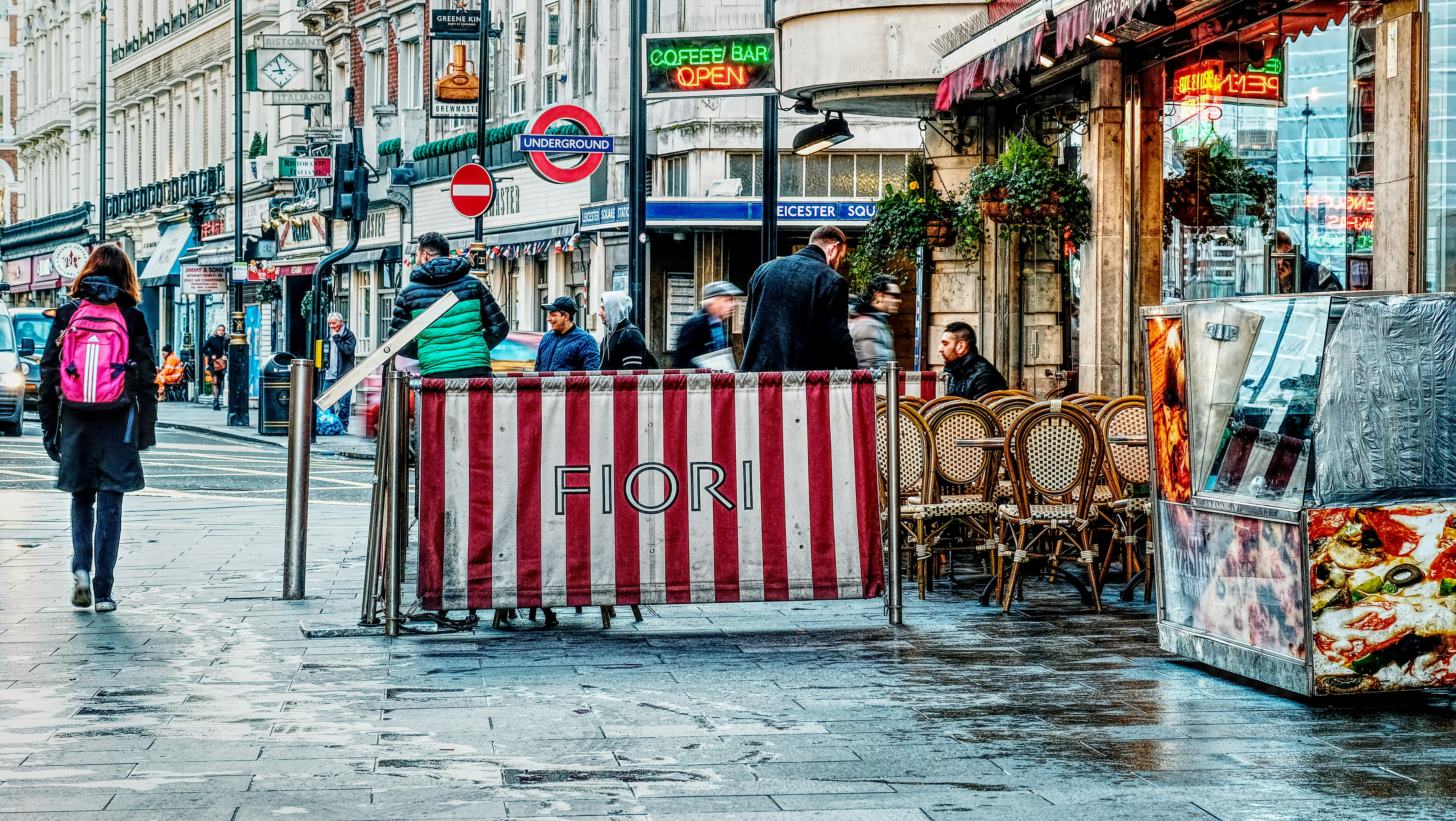 people walking beside stores during daytime