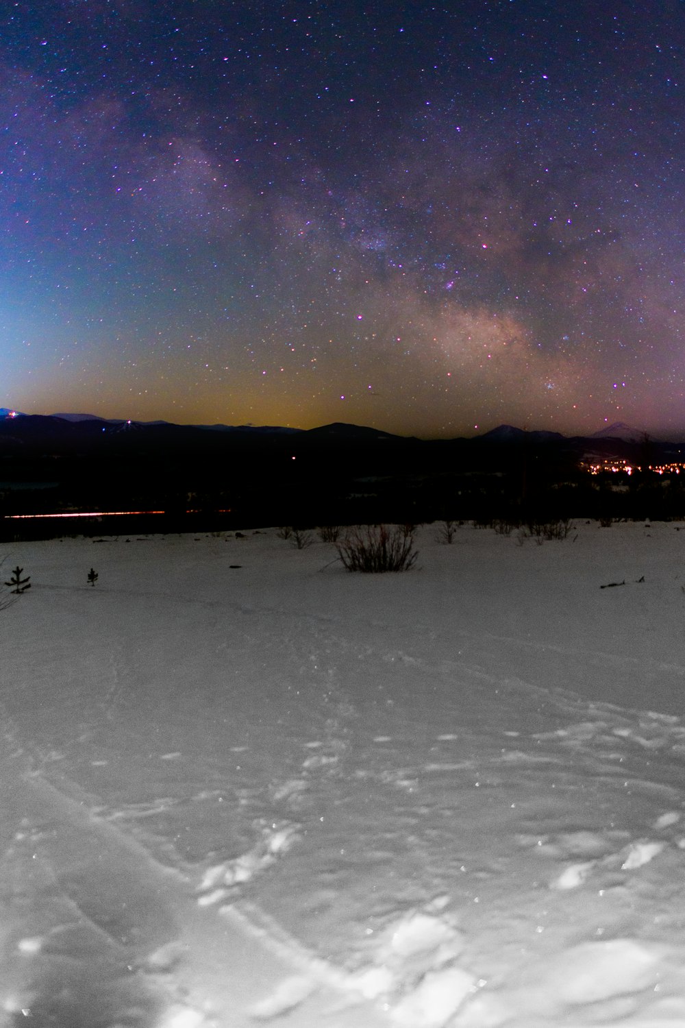 snow field near mountain under starry night