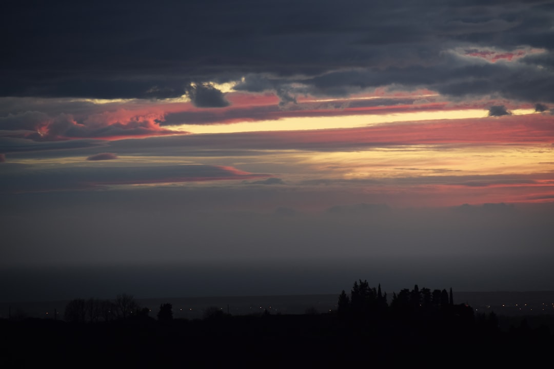 silhouette of structure under clouds