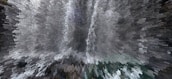 A digitally altered image creates a dynamic, pixelated effect resembling an abstract waterfall with cascading shapes and shades. The presentation is visually striking, turning an otherwise photographic scene into an intriguing piece of digital artwork.